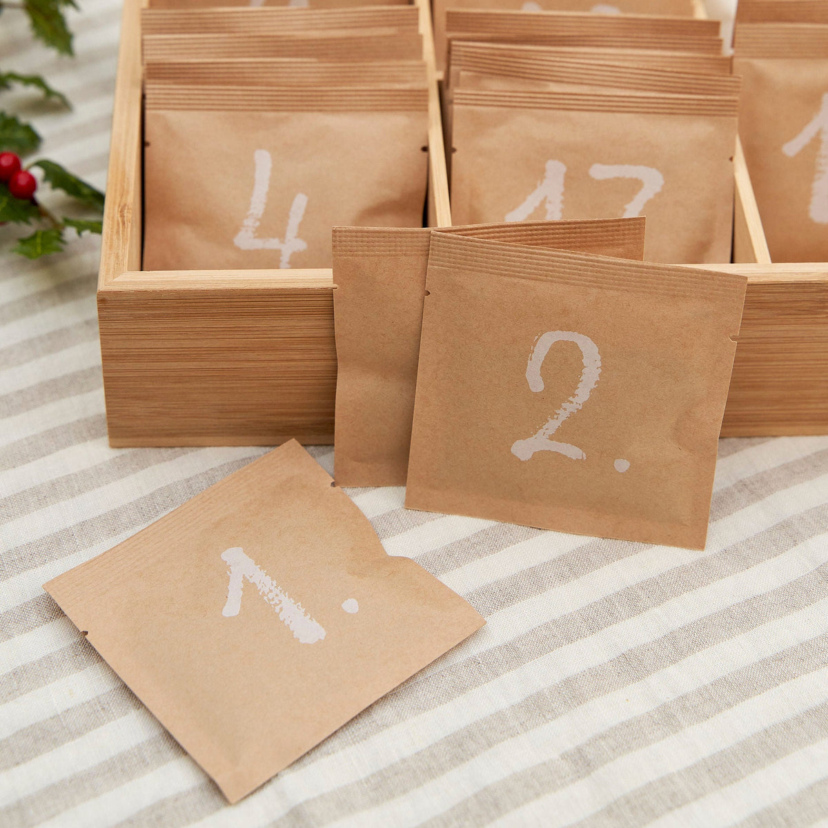 Numbered compostable paper sachets arranged in the wooden Shibui Tea Advent Calendar box
